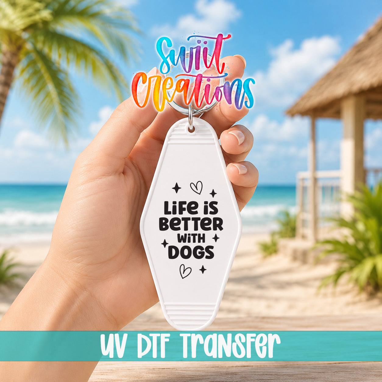 A hand holding a keychain with a message about life being better with dogs, with a beach and palm trees in the background.