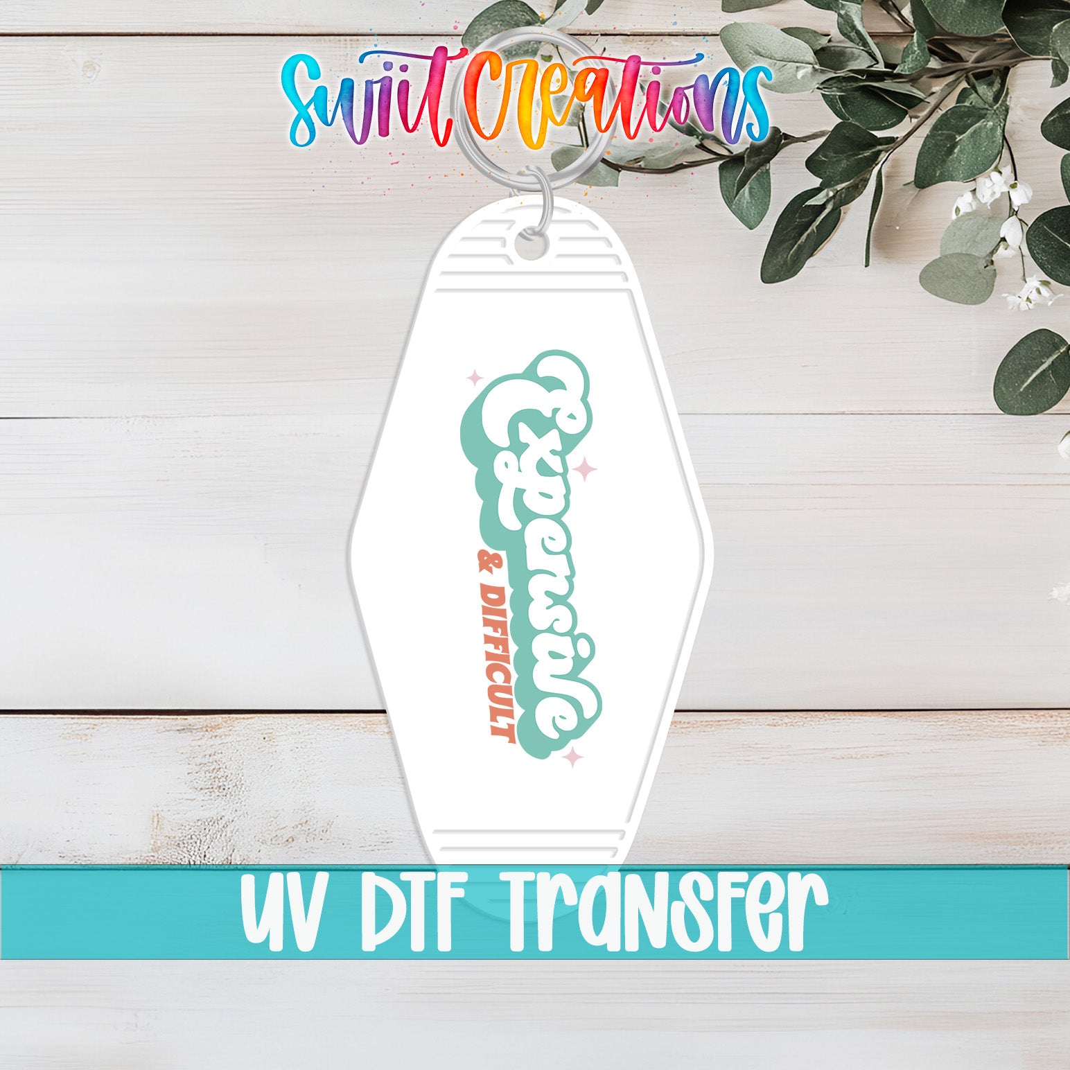 A keychain with the text "Expensive & Difficult" printed on it, along with a UVDF (UV-Detergent Free) transfer label.