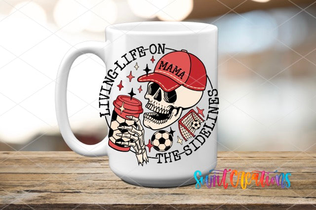 a coffee mug with a skull holding a hot dog