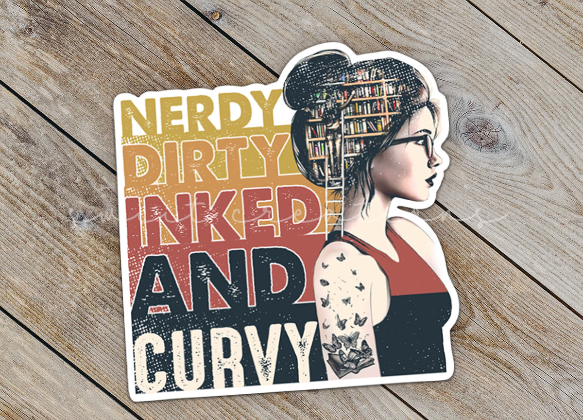 Close-up of the Nerdy Dirty Inked and Curvy sticker on rustic wood