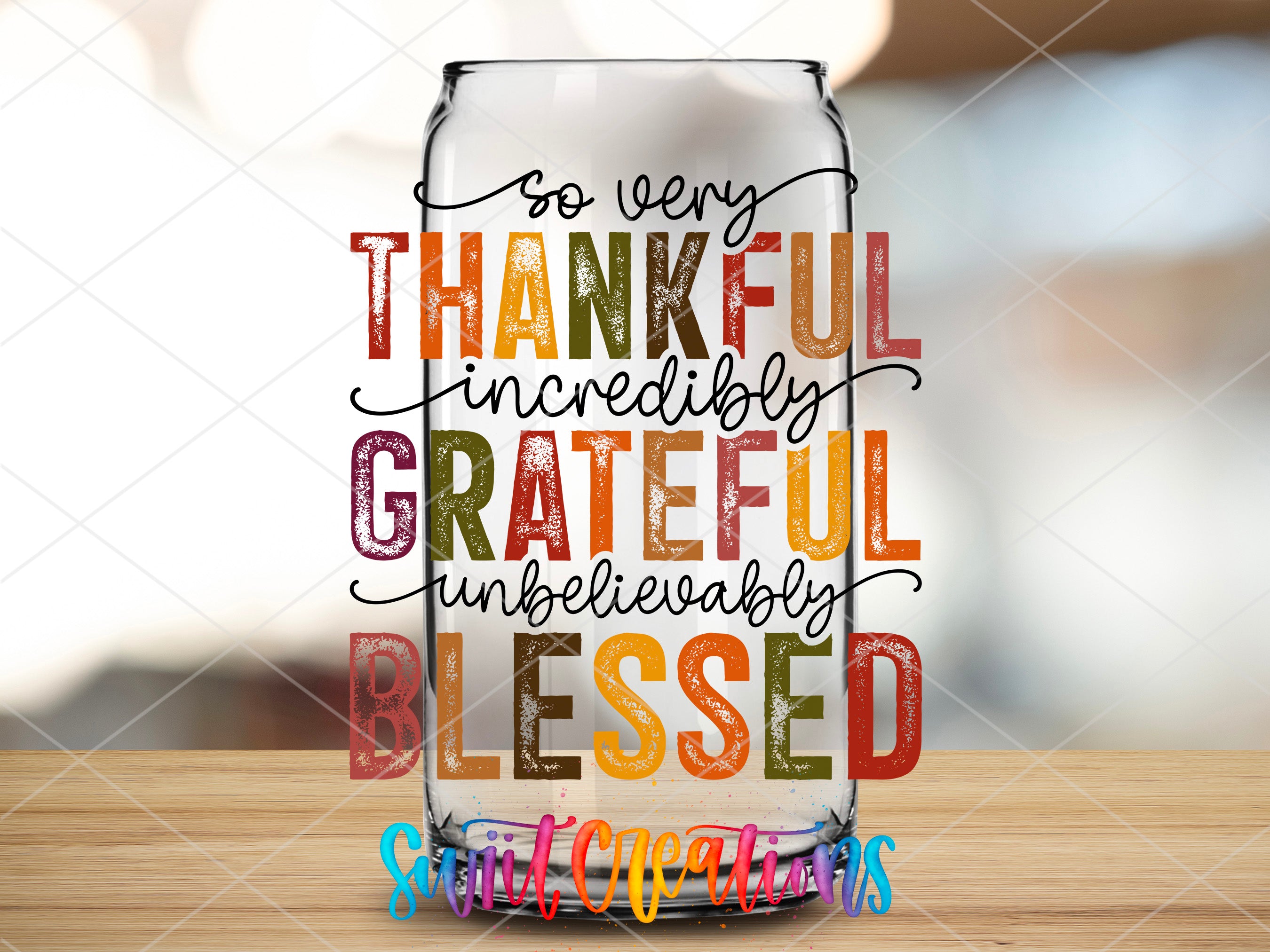 a glass filled with colorful lettering on top of a wooden table