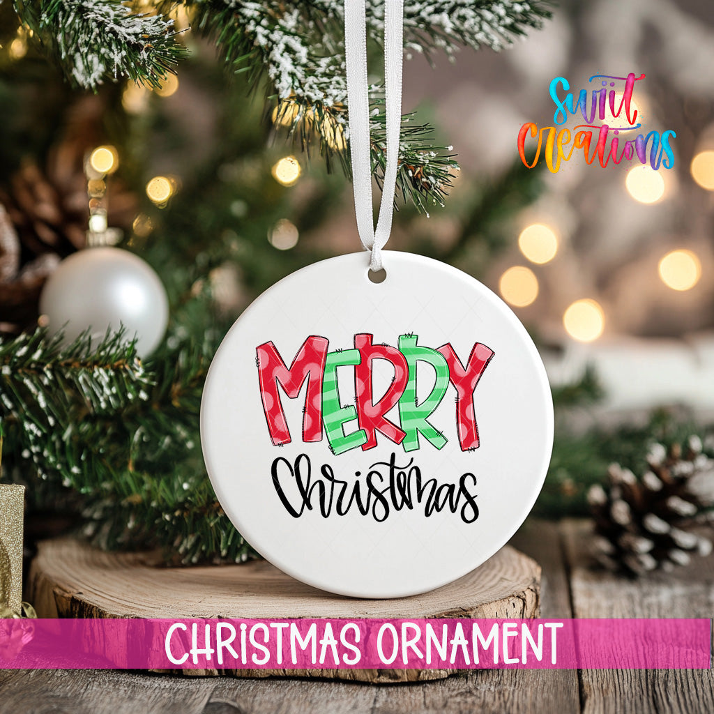 A white Christmas ornament with the text "MERRY CHRISTMAS" is hanging from a tree branch, surrounded by pine cones and other holiday decorations.
