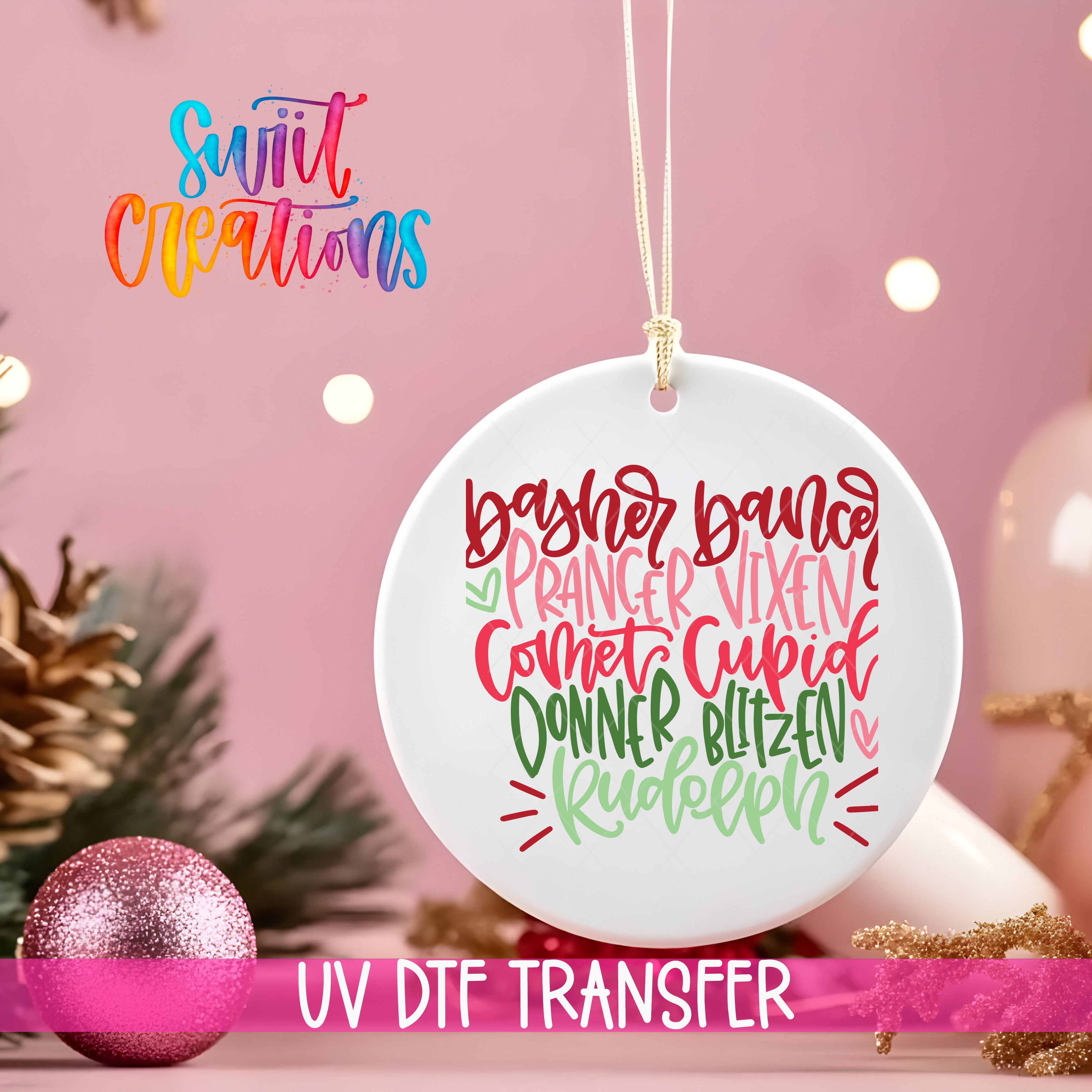 A white ornament with colorful text is hanging on a string, surrounded by Christmas decorations and a pink background.