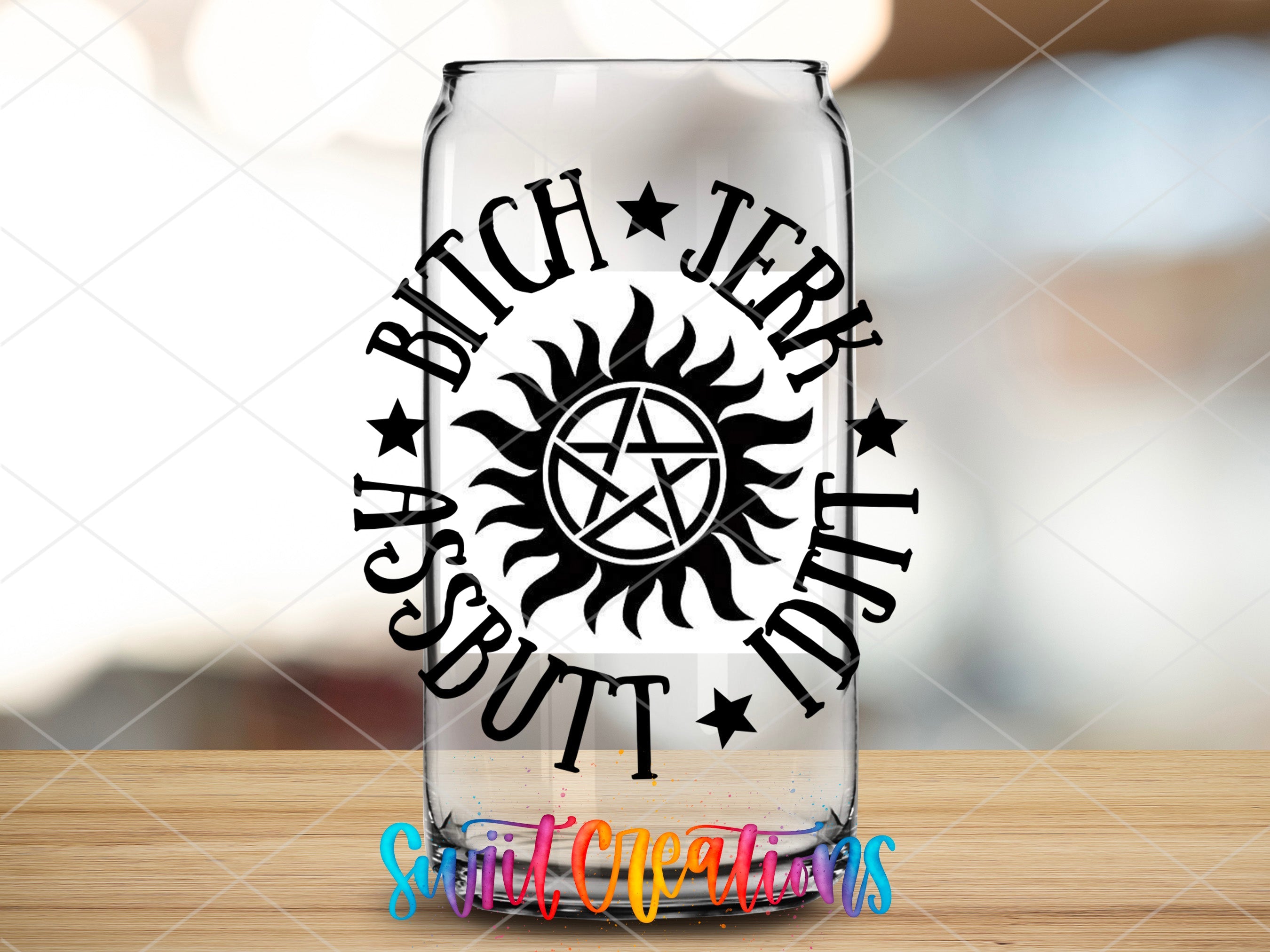 a glass with a pentagramil on it sitting on a table