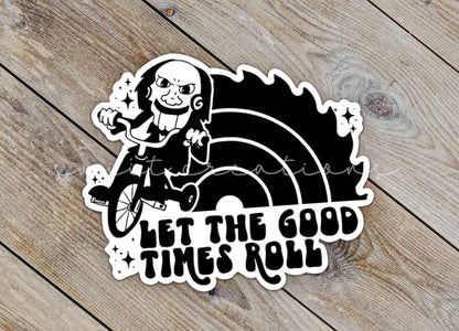 Close-up of the Let the Good Times Roll Horror sticker on rustic wood