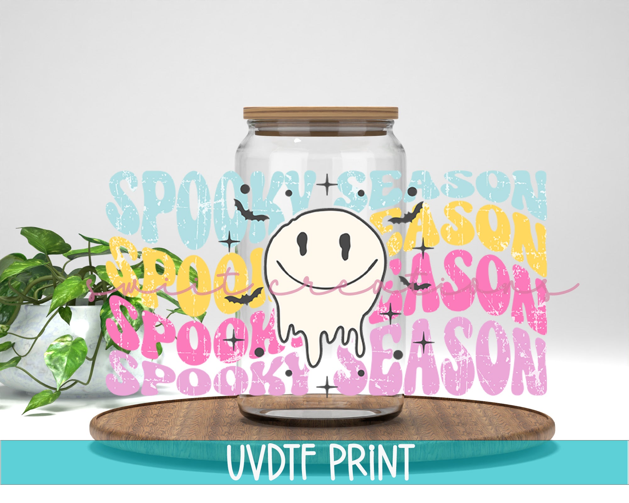 a jar with a smile on it sitting next to a plant