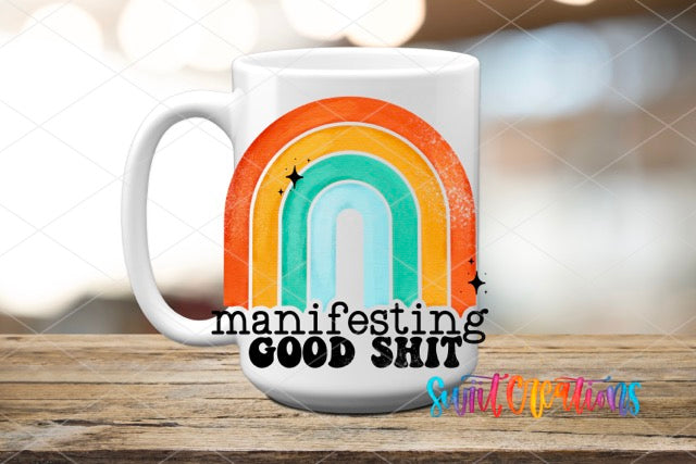a white coffee mug with a rainbow on it