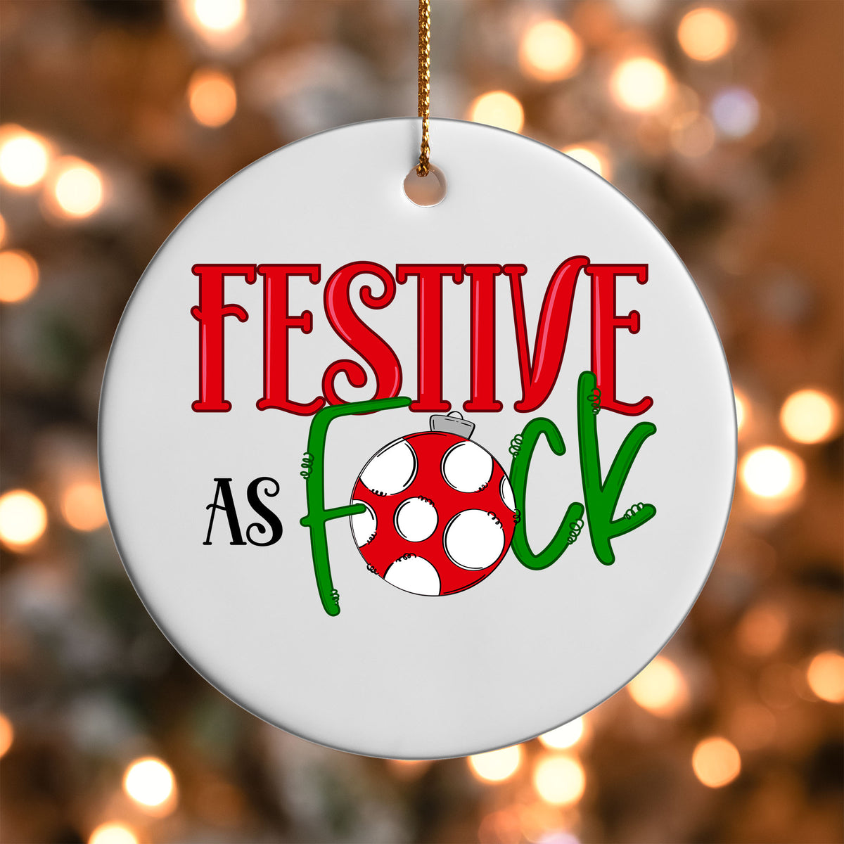 Festive As F*ck ornament UV DTF transfer on a round white ornament with a bokeh light background