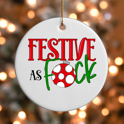 Festive As F*ck ornament UV DTF transfer on a round white ornament with a bokeh light background