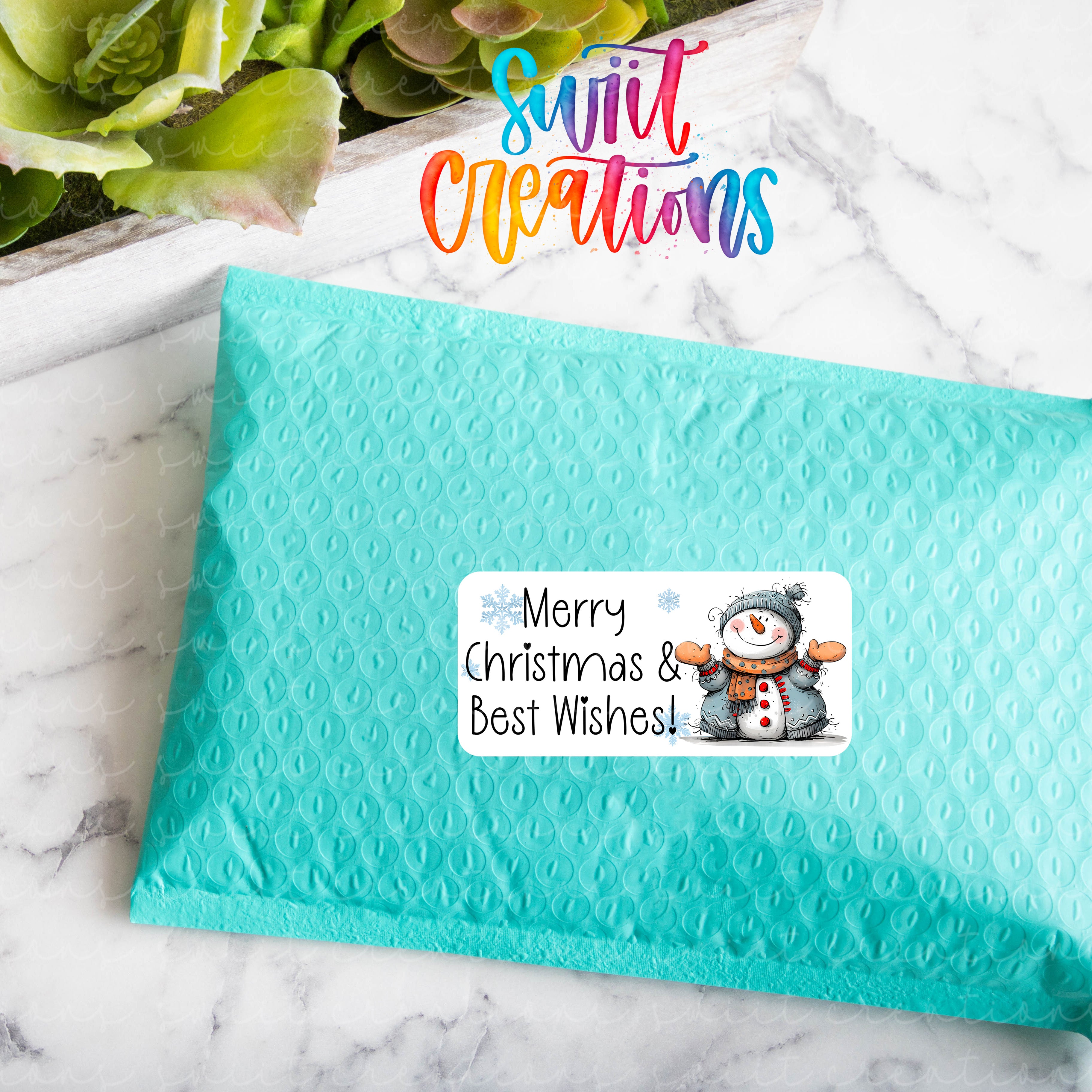 a blue envelope with a snowman sticker on it