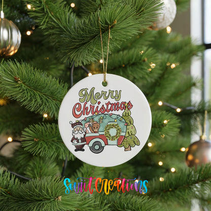 Merry Christmas Santa Camper ceramic Christmas ornament hanging on a green Christmas tree