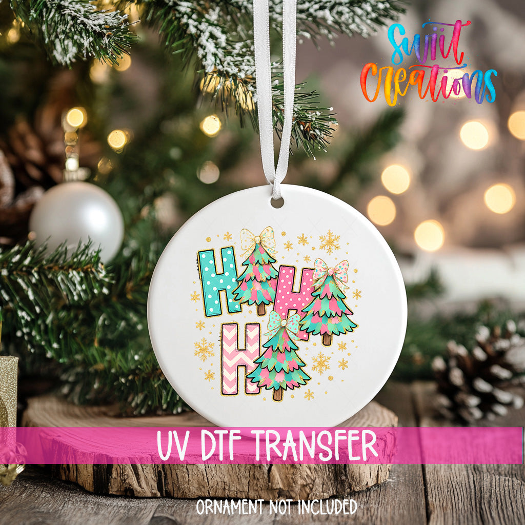 A white ornament with a colorful design hangs on a Christmas tree, surrounded by pine branches and other holiday decorations.