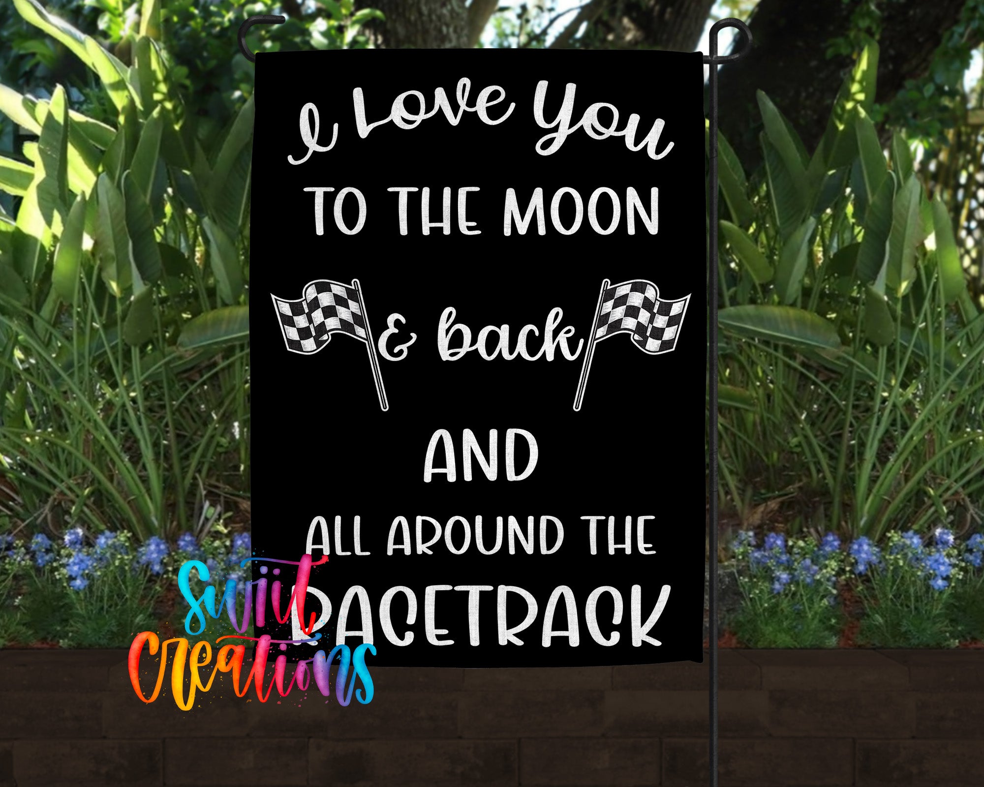 a black sign with white text that reads "I love you to the moon & back AND all around the racetrack".