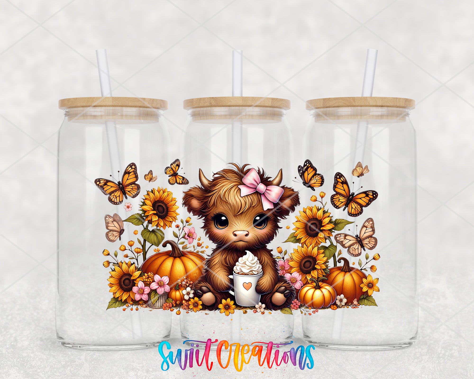 A glass tumbler with a lid, featuring a cartoon cow surrounded by flowers, pumpkins, and butterflies.