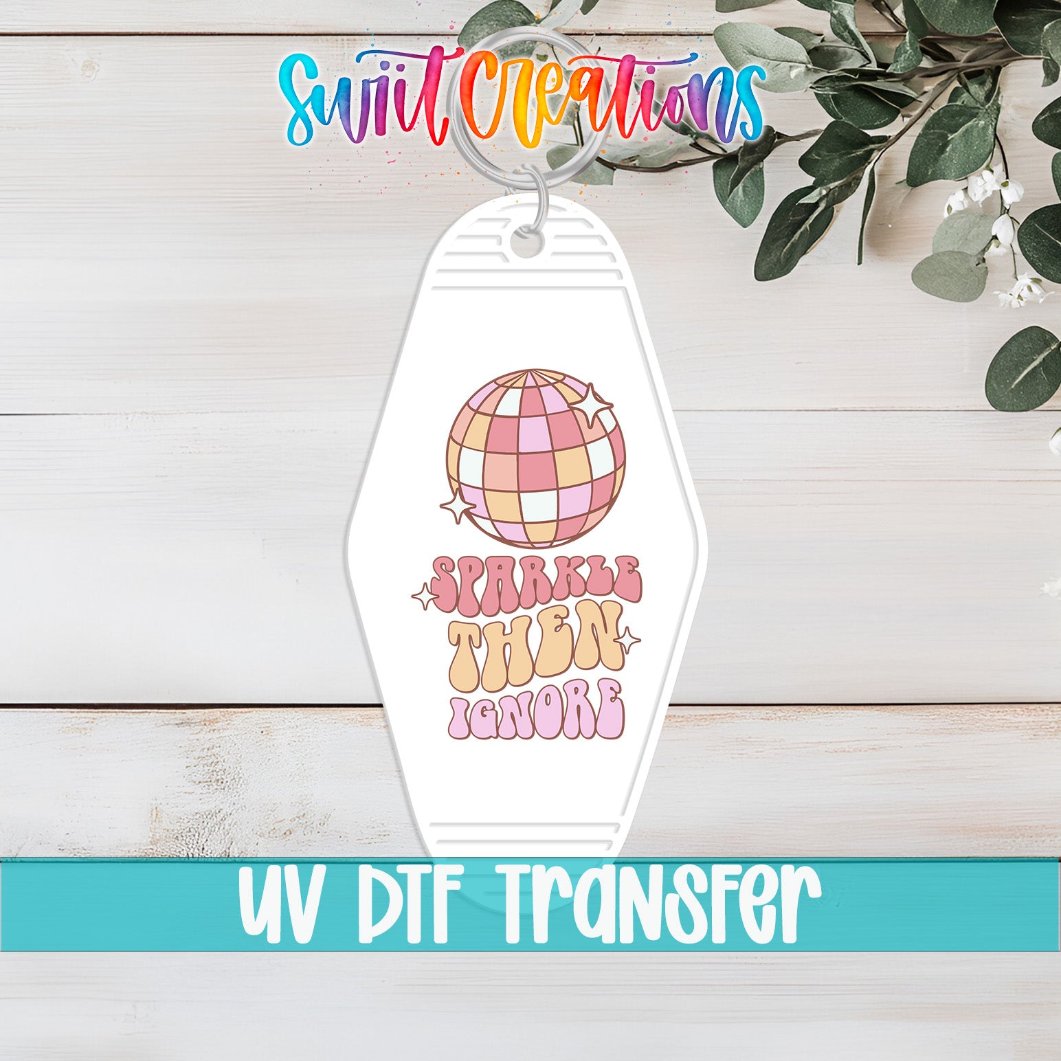 A keychain with a colorful design featuring a disco ball and the text "Sparkle then ignore" printed on it.