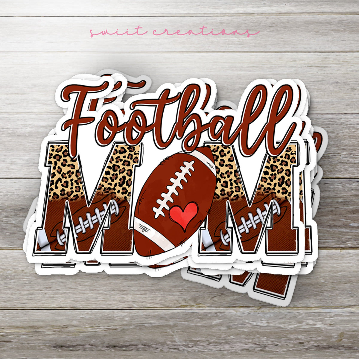 Stack of Football Mom glossy stickers on a gray wood table