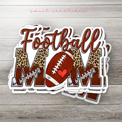 Stack of Football Mom glossy stickers on a gray wood table