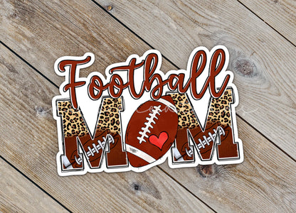 Close-up of the Football Mom sticker on rustic wood