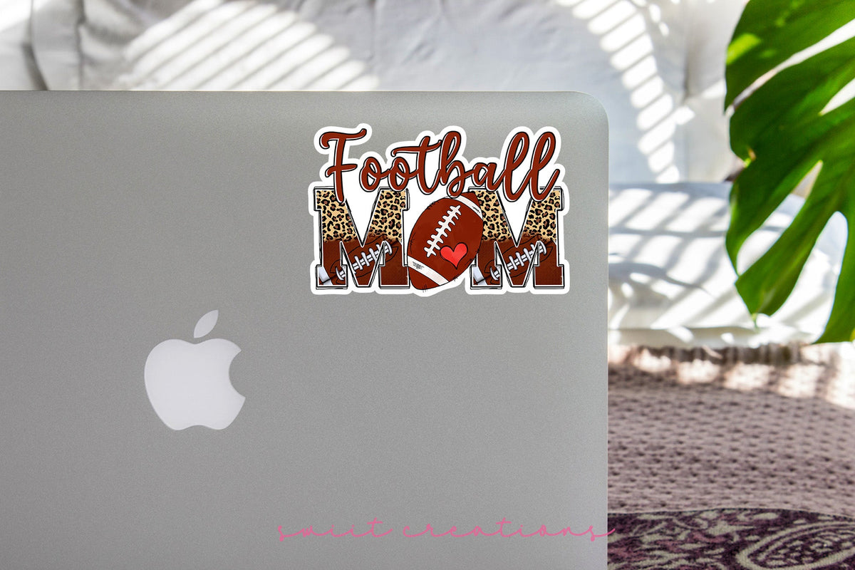 Football Mom sticker on the lid of a silver laptop