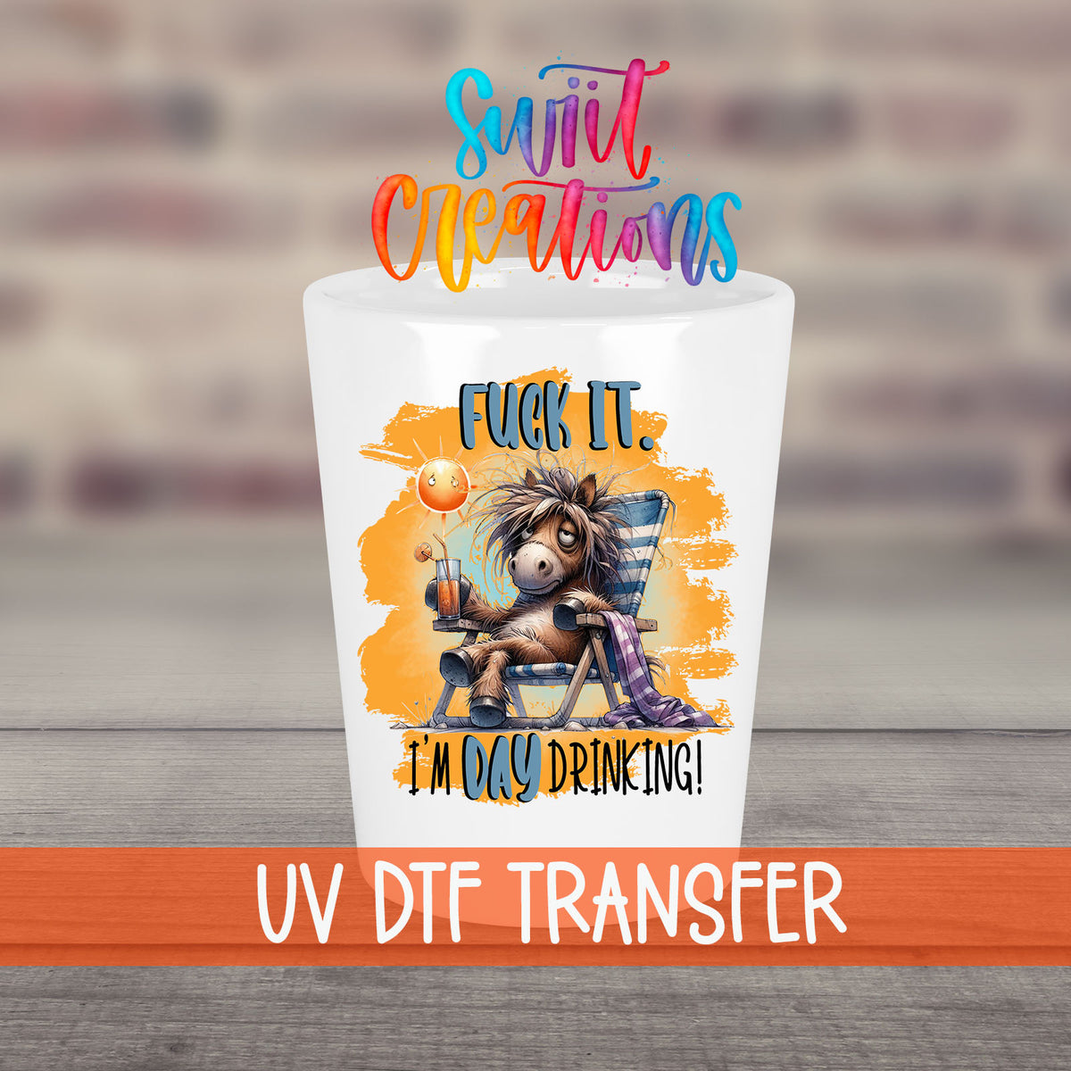 F*ck It I'm Day Drinking UV DTF transfer on a white shot glass in front of a brick wall