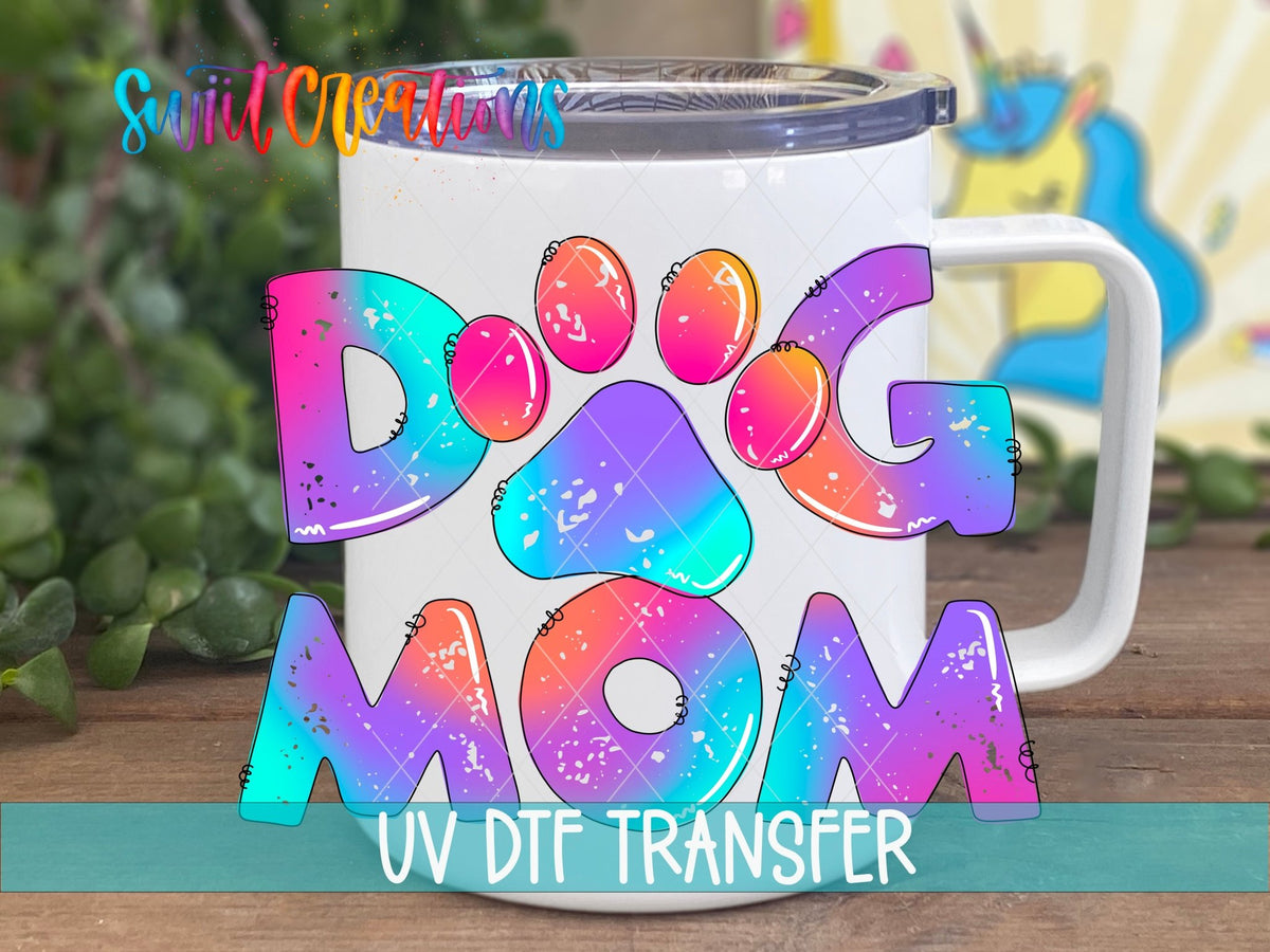 Dog Mom tie dye letters UV DTF transfer on a white stainless steel mug with a lid