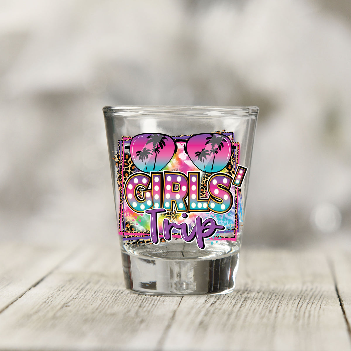 Close-up of the Girls Trip UV DTF transfer on a clear shot glass