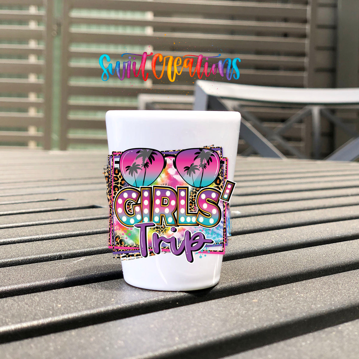 Girls Trip UV DTF transfer on a white shot glass on an outdoor patio table