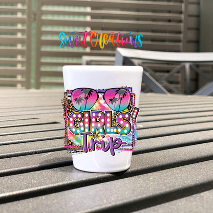 Girls Trip UV DTF transfer on a white shot glass on an outdoor patio table