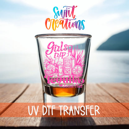 Girls Trip Tequila shot glass UV DTF transfer on a filled shot glass on a dock by the water