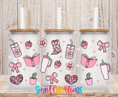 Girly Pink UV DTF wrap on three clear glass cans with bamboo lids