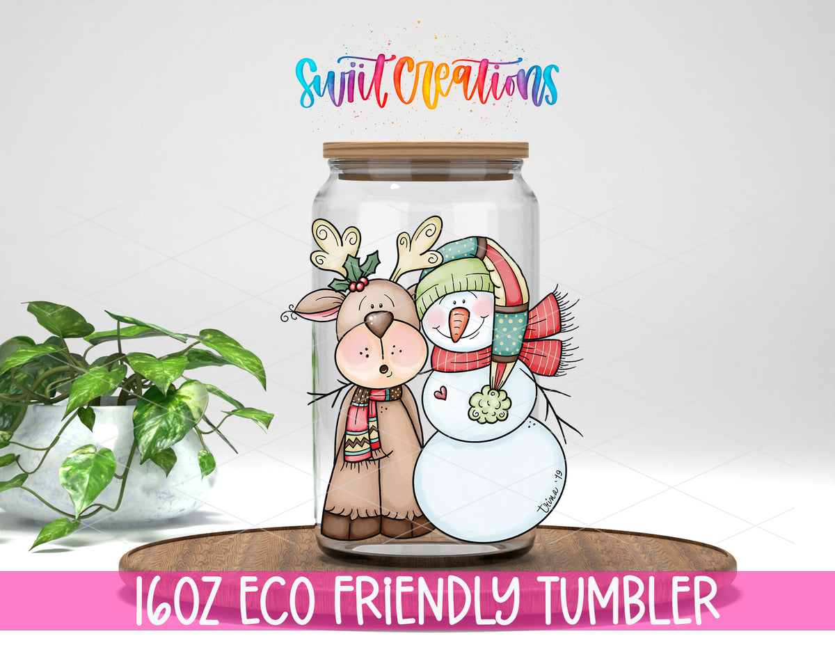 Reindeer and Snowman design on a 16 oz clear glass tumbler with bamboo lid