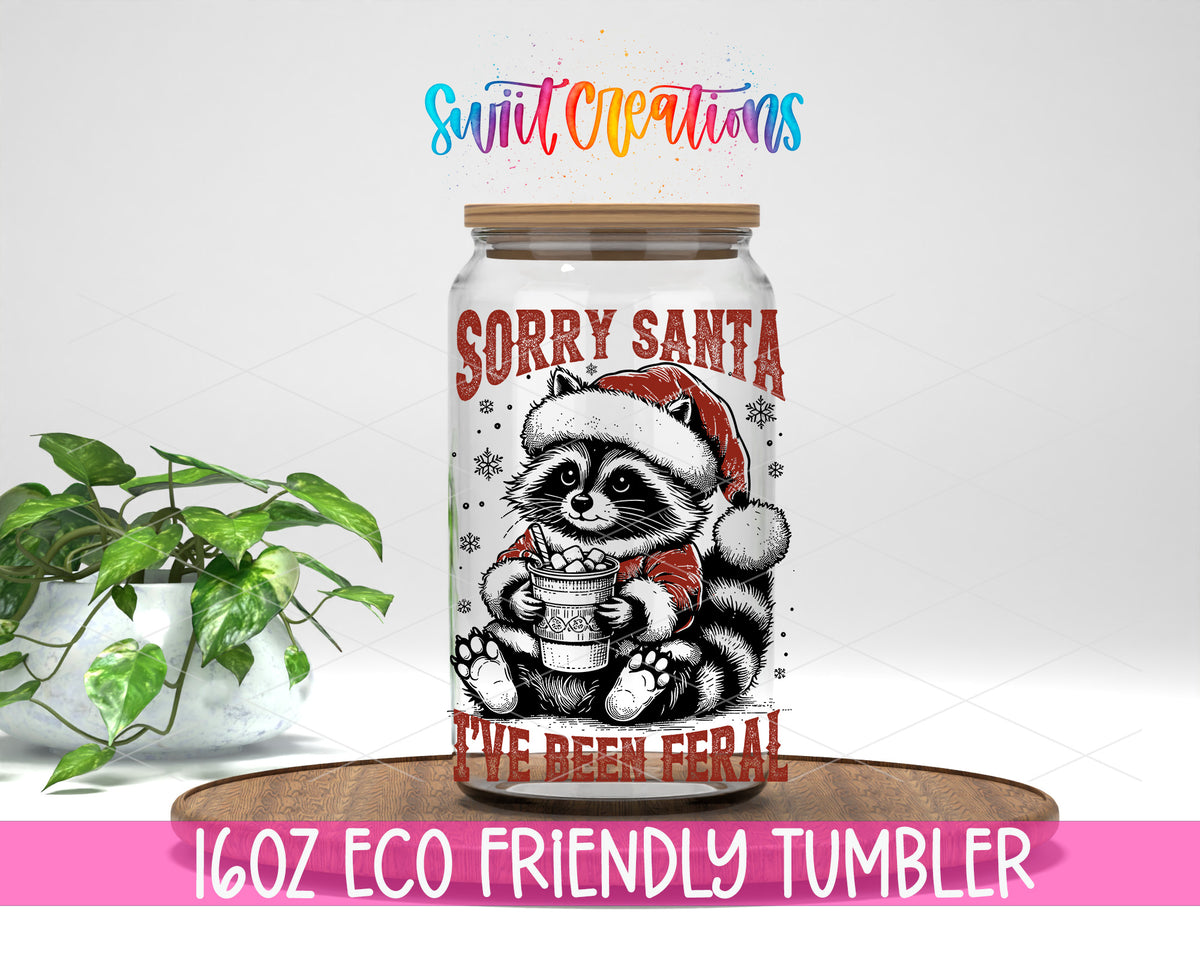 Sorry Santa Feral Raccoon design on a 16 oz clear glass tumbler with bamboo lid