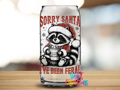 Sorry Santa Feral Raccoon design close-up on a clear glass can tumbler