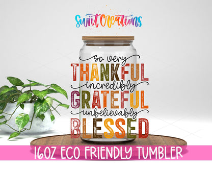 Thankful Grateful Blessed design on a 16 oz clear glass tumbler with bamboo lid