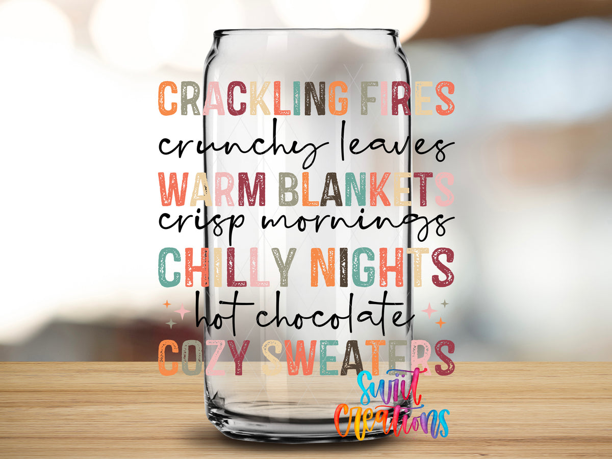 Crackling Fires Cozy Sweaters design close-up on a clear glass can tumbler