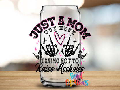 Trying Not to Raise Assholes design close-up on a clear glass can tumbler