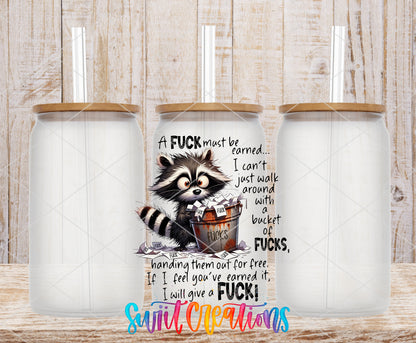 A Fuck Must Be Earned frosted glass tumbler mockup with bamboo lids and straws
