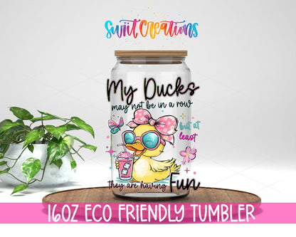 My Ducks May Not Be in a Row design on a 16 oz clear glass tumbler with bamboo lid