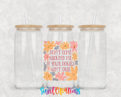 Dookies Ain't Okie clear glass tumbler group mockup with bamboo lids and straws