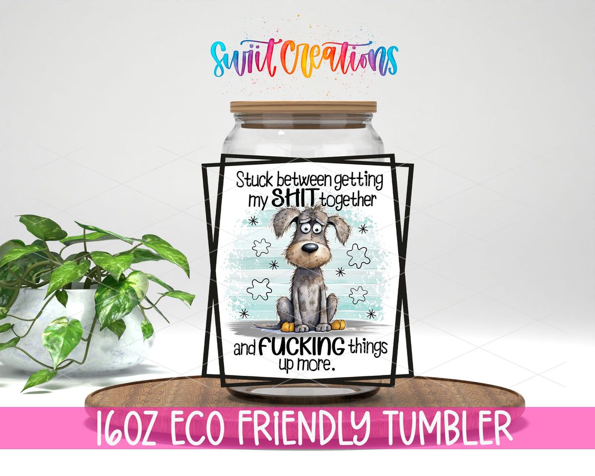 Stuck Between Getting It Together design on a 16 oz clear glass tumbler with bamboo lid