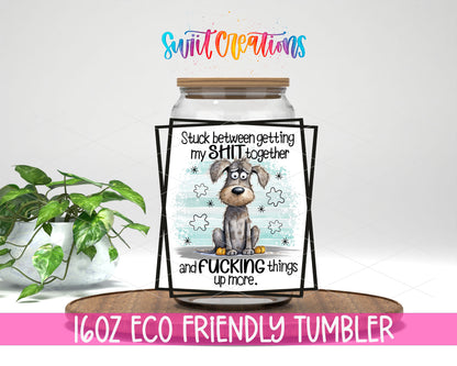 Stuck Between Getting It Together design on a 16 oz clear glass tumbler with bamboo lid