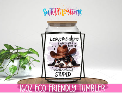 Leave Me Alone Cowboy Dog design on a 16 oz clear glass tumbler with bamboo lid