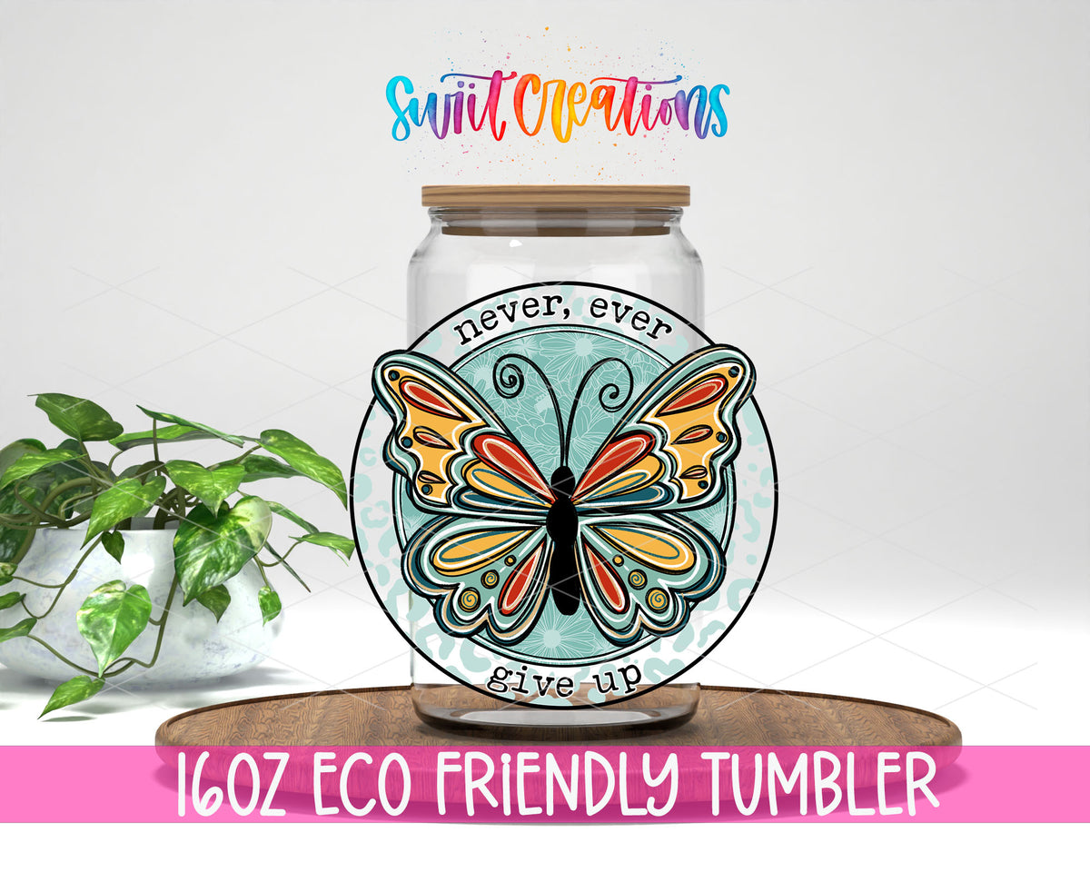 Never Ever Give Up Butterfly design on a 16 oz clear glass tumbler with bamboo lid