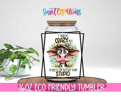 I May Be Crazy Cow design on a 16 oz clear glass tumbler with bamboo lid