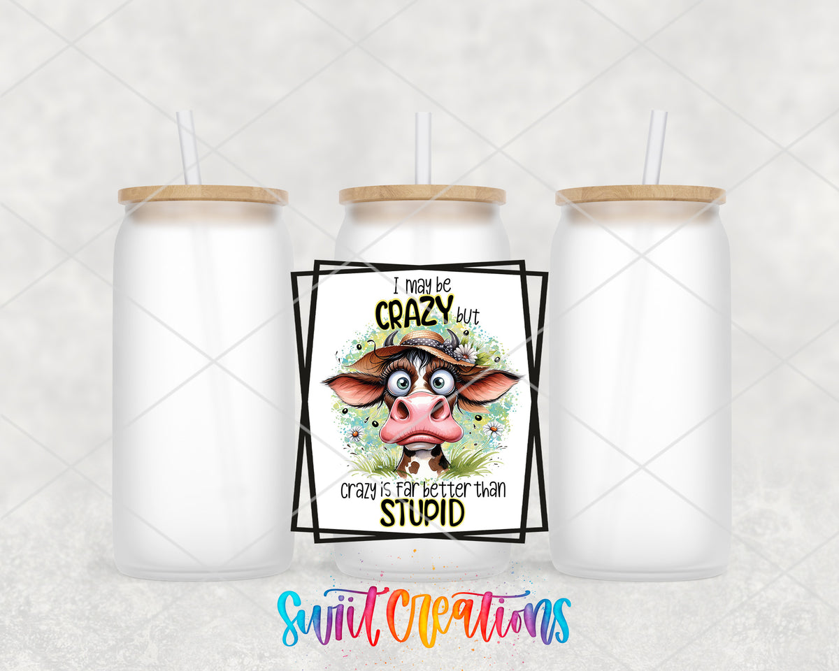 I May Be Crazy Cow frosted glass tumbler group view with lids and straws