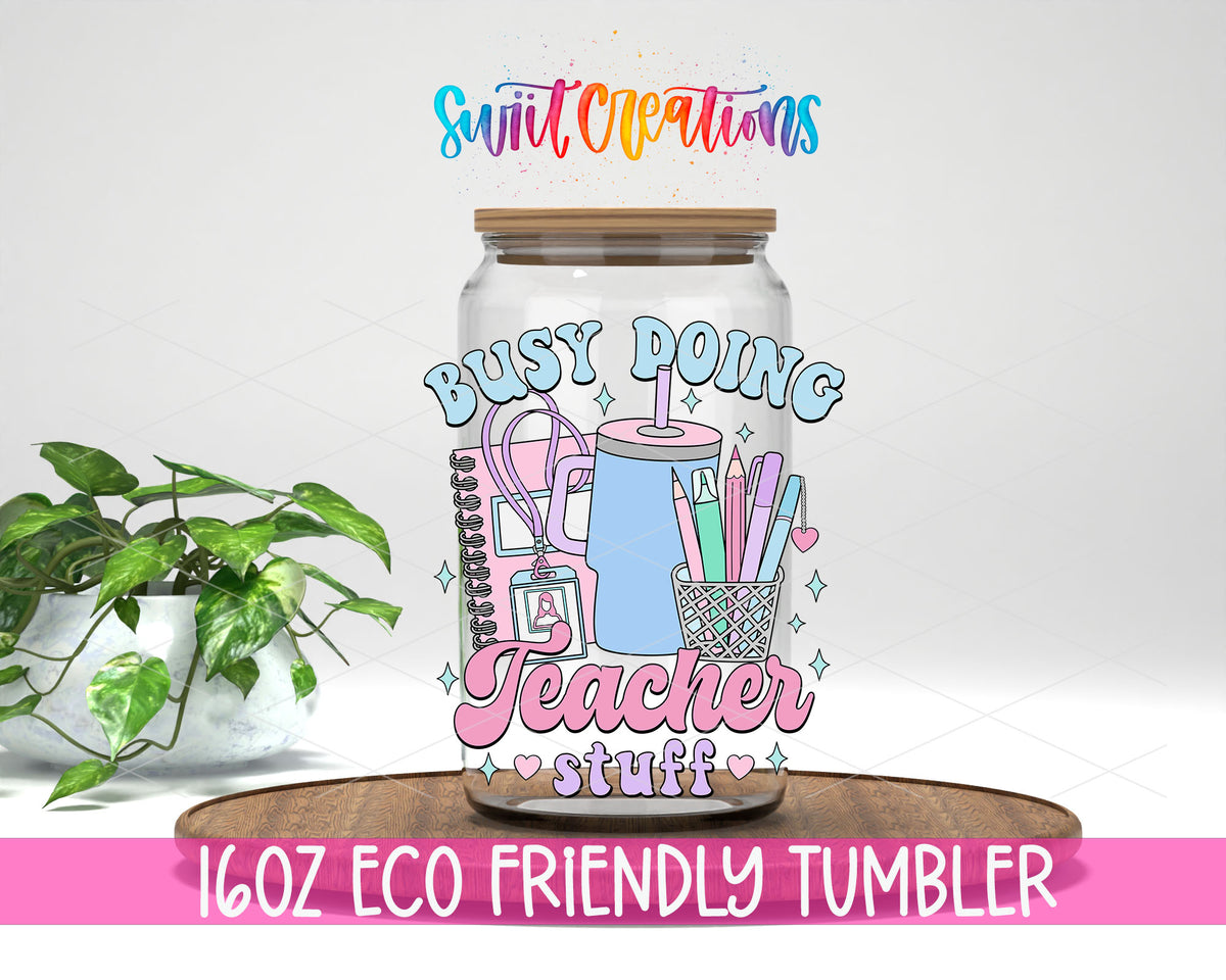 Busy Doing Teacher Stuff design on a 16 oz clear glass tumbler with bamboo lid