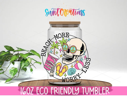 Beach More Worry Less Skull design on a 16 oz clear glass tumbler with bamboo lid