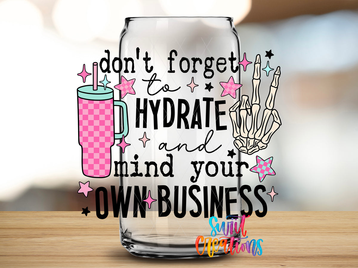 Hydrate and Mind Your Own Business design close-up on a clear glass can tumbler