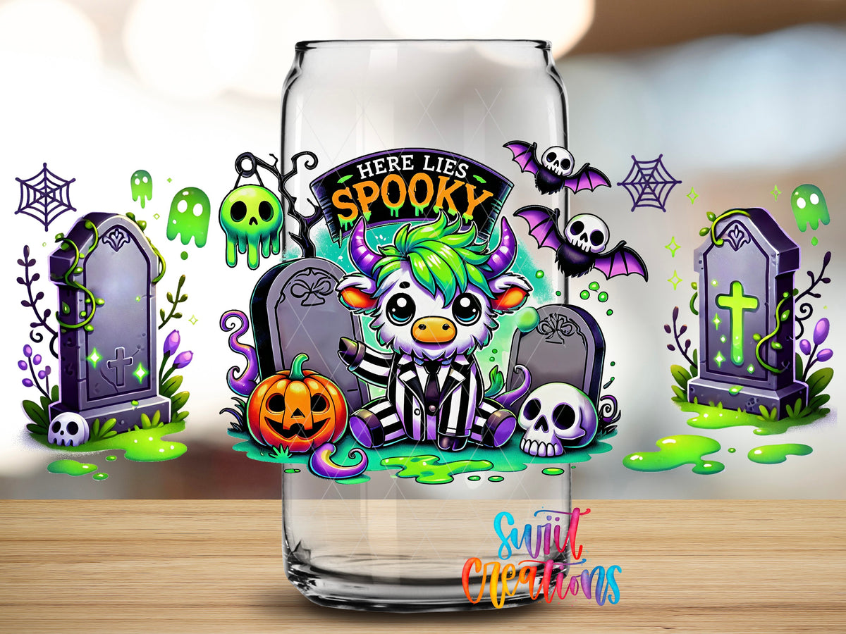 Close-up of the Here Lies Spooky highland cow graveyard UV DTF full wrap on a clear glass can