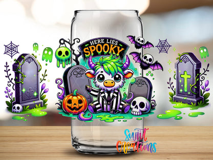Close-up of the Here Lies Spooky highland cow graveyard UV DTF full wrap on a clear glass can